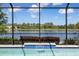 View from the pool with blue tile trim, overlooking a big beautiful lake at 12116 Stuart Dr, Venice, FL 34293