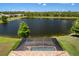 View of screened pool and lake creating a private oasis in this beautiful community at 12116 Stuart Dr, Venice, FL 34293