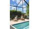 Comfortable lounge chairs by the pool on brick pavers offering a tranquil setting with a water view at 12116 Stuart Dr, Venice, FL 34293