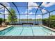 Sparkling pool and screened in lanai with lake views providing a serene outdoor living space at 12116 Stuart Dr, Venice, FL 34293