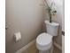 Well-maintained powder room with a toilet, tissue paper, and small decorations at 12116 Stuart Dr, Venice, FL 34293