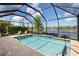 Relaxing screened-in pool area with pavers and waterfront views, creating a serene outdoor living space at 12116 Stuart Dr, Venice, FL 34293