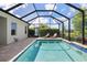 Inviting screened-in pool with comfortable lounge chairs and brick pavers, creating a relaxing outdoor retreat at 12116 Stuart Dr, Venice, FL 34293