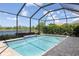 Screened-in pool with waterfront views, pavers, and meticulously maintained landscaping, offering a private escape at 12116 Stuart Dr, Venice, FL 34293