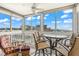 Enclosed balcony with views to the city and ocean, plus fan and comfortable rocking chair at 1255 Tarpon Center Dr # 309, Venice, FL 34285