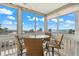 Enclosed balcony with sweeping views of the ocean and comfortable seating area at 1255 Tarpon Center Dr # 309, Venice, FL 34285