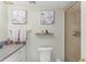 Updated bathroom featuring a decorative vanity and shelving with framed artwork at 1255 Tarpon Center Dr # 309, Venice, FL 34285