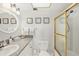 All-white bathroom featuring a shower/tub combo, round mirror, and granite countertops at 1255 Tarpon Center Dr # 309, Venice, FL 34285