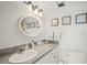 Bright bathroom featuring a shower/tub combo, round mirror, and granite countertops at 1255 Tarpon Center Dr # 309, Venice, FL 34285
