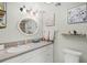 Updated bathroom featuring a decorative vanity and shelving with framed artwork at 1255 Tarpon Center Dr # 309, Venice, FL 34285