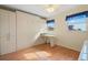 Light-filled bedroom featuring a built-in wall bed and desk near bright windows at 1255 Tarpon Center Dr # 309, Venice, FL 34285
