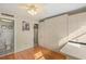 Bright bedroom featuring a Murphy bed, wood floors, ceiling fan, closet, and en suite bathroom for convenience at 1255 Tarpon Center Dr # 309, Venice, FL 34285
