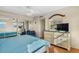 Well-lit bedroom features a mirrored closet, a comfortable chair, and light wood flooring at 1255 Tarpon Center Dr # 309, Venice, FL 34285