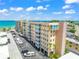 Low angle view of the condo exterior showing balconies, parking, and exterior design at 1255 Tarpon Center Dr # 309, Venice, FL 34285