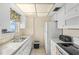 Bright kitchen featuring tile floors, modern appliances, and a large window overlooking the sea at 1255 Tarpon Center Dr # 309, Venice, FL 34285