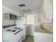 Compact kitchen with vintage appliances, a microwave, and tile flooring at 1255 Tarpon Center Dr # 309, Venice, FL 34285