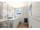 Well-lit laundry room with two washing machines, a dryer, and a utility sink at 1255 Tarpon Center Dr # 309, Venice, FL 34285