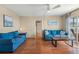 Bright living room with access to the balcony and a view into the hallway at 1255 Tarpon Center Dr # 309, Venice, FL 34285