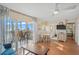 Bright living room with a ceiling fan, access to the balcony and views to the kitchen and a main bedroom at 1255 Tarpon Center Dr # 309, Venice, FL 34285