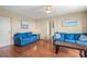 Comfortable living room with ceiling fan and a view into the hallway at 1255 Tarpon Center Dr # 309, Venice, FL 34285