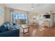 Bright living room with ceiling fan, dining area, and access to the balcony at 1255 Tarpon Center Dr # 309, Venice, FL 34285