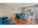 Bright living room with water view, ceiling fan, and access to the balcony at 1255 Tarpon Center Dr # 309, Venice, FL 34285