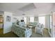 Comfortable lounge area with sofas, chairs, a glass coffee table, and plenty of natural light at 1255 Tarpon Center Dr # 309, Venice, FL 34285