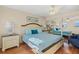 Main bedroom has a mirrored closet, light colored walls, and light-colored wood floors at 1255 Tarpon Center Dr # 309, Venice, FL 34285