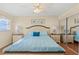 Serene Main Bedroom with large window, ceiling fan, and mirrored closet at 1255 Tarpon Center Dr # 309, Venice, FL 34285