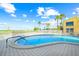 Community pool with ocean views surrounded by palm trees at 1255 Tarpon Center Dr # 309, Venice, FL 34285