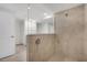 Tiled walk-in shower with rainfall showerhead and tiled floors at 12680 Radiance Ct # 12-101, Venice, FL 34293