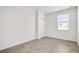 Brightly lit bedroom with neutral paint and decorative floor tiling; includes a sunny window and closet at 12680 Radiance Ct # 12-101, Venice, FL 34293