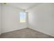 Well lit bedroom with neutral paint and decorative floor tiling; includes a bright window with white blinds at 12680 Radiance Ct # 12-101, Venice, FL 34293