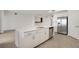 Kitchen island featuring stainless steel appliances, and white cabinets at 12680 Radiance Ct # 12-101, Venice, FL 34293