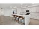 Modern kitchen with barstool seating at the island and stainless steel appliances at 12680 Radiance Ct # 12-101, Venice, FL 34293
