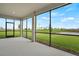 A large screened in lanai looks out over a manicured lawn and a peaceful, scenic pond at 12680 Radiance Ct # 12-101, Venice, FL 34293