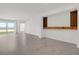 Bright living room with tile floors, built-in shelves, and sliding glass doors to the outside at 12680 Radiance Ct # 12-101, Venice, FL 34293