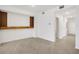 Living room showcasing tile floors and a built-in shelving feature with a wooden accent at 12680 Radiance Ct # 12-101, Venice, FL 34293