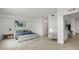 Bright main bedroom featuring tiled floors, neutral decor, and a king bed at 12680 Radiance Ct # 12-101, Venice, FL 34293