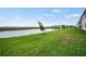 Scenic view of a pond surrounded by manicured lawn and community buildings, ideal for outdoor activities at 12680 Radiance Ct # 12-101, Venice, FL 34293