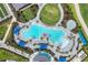 Aerial view of a luxurious community pool with ample seating, landscaping, and lounge area at 12680 Radiance Ct # 12-101, Venice, FL 34293