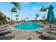 A resort style pool is surrounded by lounge seating and a splash pad with beautiful landscaping at 12680 Radiance Ct # 12-101, Venice, FL 34293