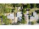 Aerial view of a home surrounded by trees, other houses, and a lawn at 1345 24Th St, Sarasota, FL 34234