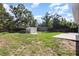 Large backyard featuring a storage shed, a shipping container, and green grass at 1345 24Th St, Sarasota, FL 34234