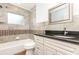 Bathroom features tile surround, a shower-tub combination, and granite countertop at 1345 24Th St, Sarasota, FL 34234