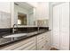 The bathroom features double sinks with granite countertop, ample cabinetry, and a large mirror at 1345 24Th St, Sarasota, FL 34234