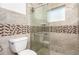 Beautiful bathroom featuring glass shower door, tile details, and a modern toilet at 1345 24Th St, Sarasota, FL 34234