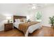 A cozy bedroom features a comfortable bed, ceiling fan, and a large window at 1345 24Th St, Sarasota, FL 34234