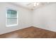 The bedroom features a large window providing plenty of natural light and wood-look floors at 1345 24Th St, Sarasota, FL 34234