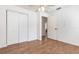 Bright bedroom featuring wood-look floors, a ceiling fan, and a closet with double doors at 1345 24Th St, Sarasota, FL 34234
